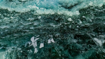 Cracked Turquoise Ice on Frozen Lake