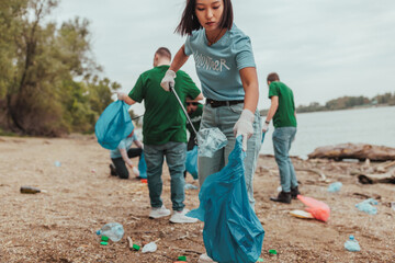 Volunteers cleaning a polluted river bank: teamwork and environmental protection