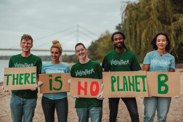Volunteers showing there is no planet b sign by the river