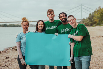 Volunteers holding blank banner near river promoting environmental awareness