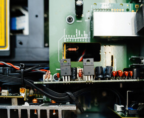 A detailed view of the inner workings of a digital hi-fi amplifier showcasing capacitors, wiring, and intricate circuitry