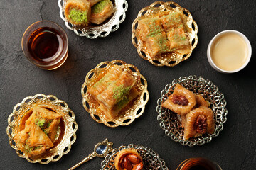 Baklava and tea served on ornate plates at a traditional dessert gathering in the afternoon