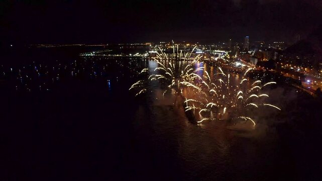 Nocturne aerial view of the fireworks launched in the beach of El Postiguet, in the Mediterranean city of Alicante, Spain.