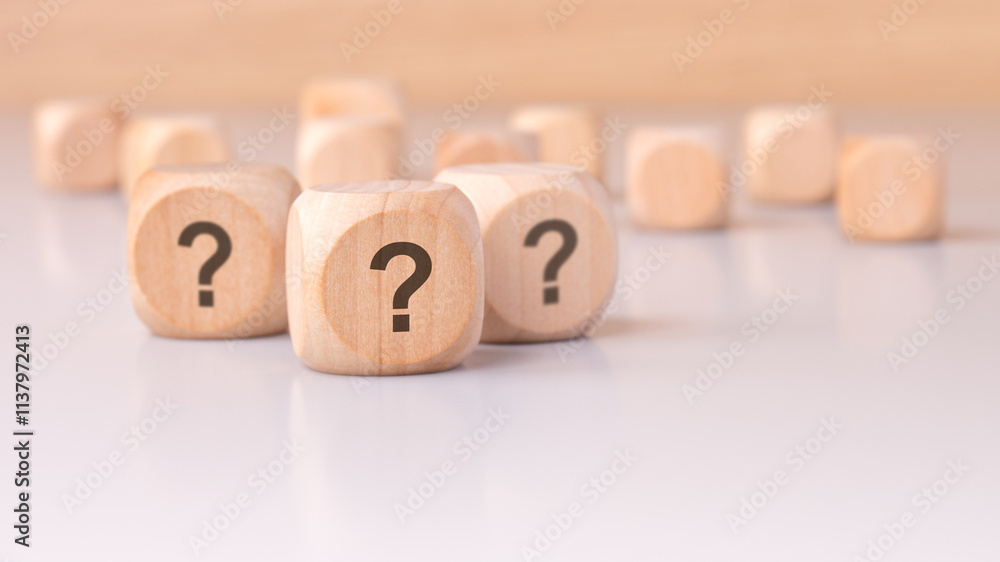 Aufkleber on the table sits a collection of mysterious wooden blocks adorned with question marks