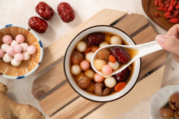 Red and white tangyuan with syrup soup, dried longan pulp, red dates for Winter solstice.