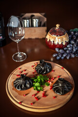 black khinkali on a restaurant table