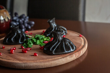 black khinkali on a restaurant table