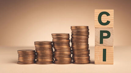 Stacked coins with CPI blocks representing consumer price index growth  
