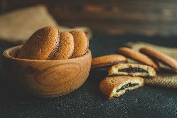 Homemade cookies in a wooden plate, background
