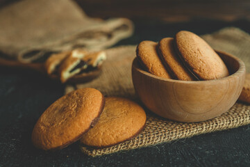 Homemade cookies in a wooden plate, background
