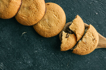 Shortbread cookies with chocolate filling on a wooden spoon, background sweets