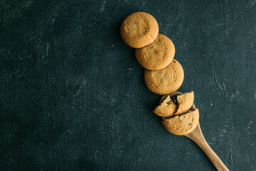 Shortbread cookies with chocolate filling on a wooden spoon, background sweets