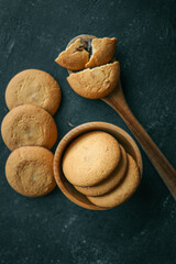 Shortbread cookies with chocolate filling on a wooden spoon, background sweets