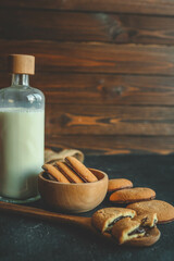 Homemade with chocolate filling on a wooden spoon and a bottle of milk, good morning