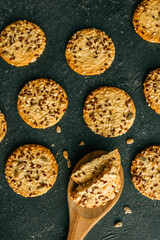 Wooden spoon with homemade cookies with siftings and flax