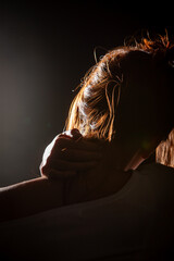 A stunning and beautiful silhouette that captures a tender and loving embrace illuminated by gentle lighting