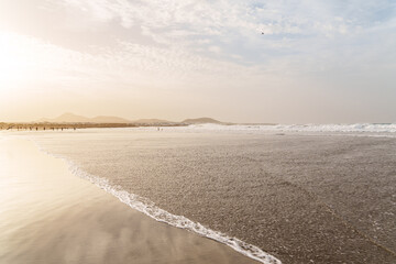 Obraz premium Beautiful Farmaca sandy beach in golden sunset at Lanzarote, Canary Island