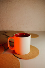 White cup with cork coasters on a light background