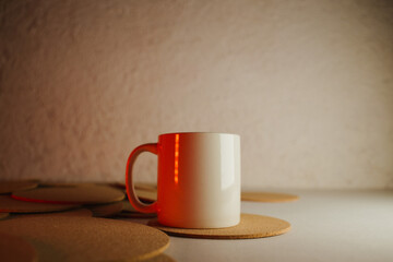 White cup with cork coasters on a light background