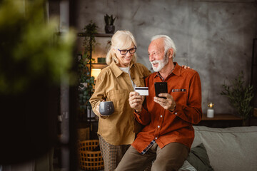 senior husband and wife shop online on mobile phone with credit card