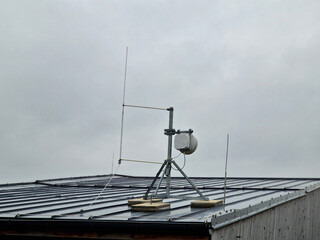 internet signal amplifier is located on roof of the family house. parabolic antennas heatsink...