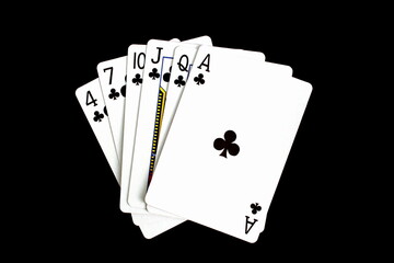 Obraz premium Playing cards of the same suit lie on a black background.