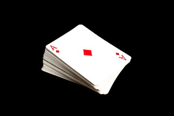 A deck of cards lies on a black background.