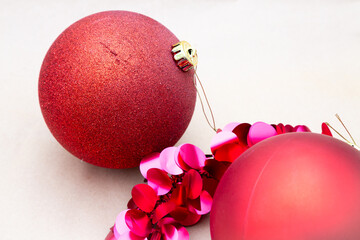 Two bright red Christmas ornaments are beautifully sitting close to each other