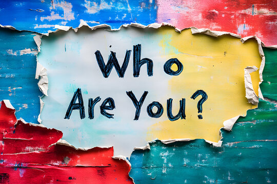 Ripped colorful paper with bold text "Who Are You?" on yellow and blue background, symbolizing identity, self-discovery, personality, motivation, curiosity, and introspection