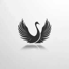 Obraz premium Elegant black swan silhouette with spread wings and reflection.