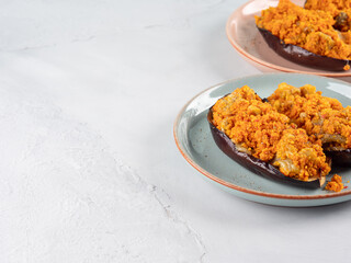 Baked eggplants stuffed with corn couscous with chickpea sauce
