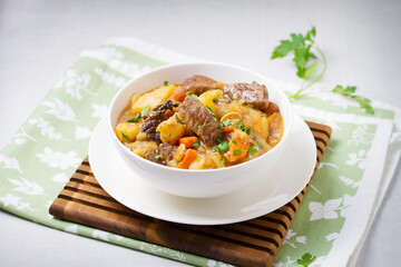 Slow cooked beef stew with potatoes, carrots and onions