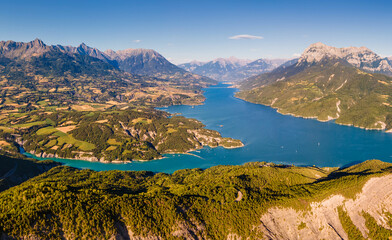 Aerial late day view of Serre-Poncon Lake and Durance Valley with Grand Morgon peak. Chanteloube Bay, Hautes-Alpes, Alps, France