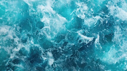 Obraz premium Aerial view of vibrant turquoise sea water surface with gentle waves and frothy white foam creating a dynamic oceanic texture.