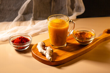 Immunity drink with turmeric powder. Turmeric tea. Trendy healthy drink with curcuma spices. Herbal beverage for health and normal bowel function