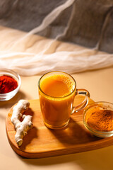 Immunity drink with turmeric powder. Turmeric tea. Trendy healthy drink with curcuma spices. Herbal beverage for health and normal bowel function