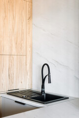 Modern black sink and faucet design in a stylish kitchen interior