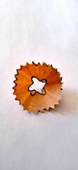 Pencil shaving round shaped debris after the sharpening of pencil by sharpener over the white background.