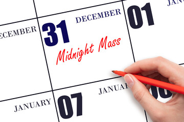 December 31. Hand writing text Midnight Mass on calendar date. Save the date.