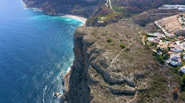 Aerial view of the wonderful Cala del Moraig and Cala de los Tiestos, located between the beautiful cliffs of the town of Benitachell, in the Mediterranean province of Alicante, Spain.