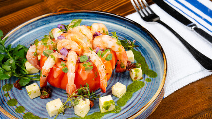 The harmony of shrimp and tomatoes in a seafood platter. Elegantly presented shrimp with tomato sauce. Delicious dinner.