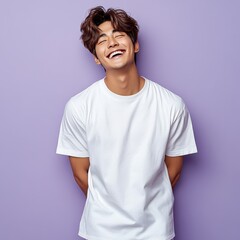 man with casual t-shirt is smiling at the camera, solid color background