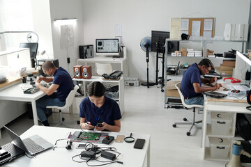 Engineers Working on Electronics Prototypes in Office