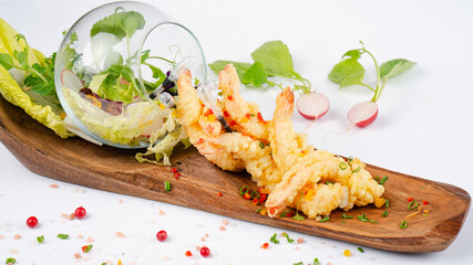 Fresh shrimp tempura. A delicious serving of shrimp tempura garnished with fresh vegetables. Healthy dinner.