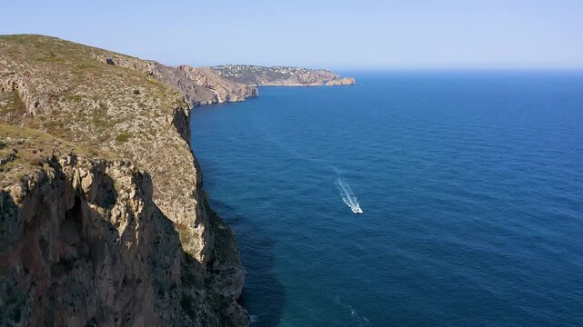 Aerial view of the wonderful Cala del Moraig and Cala de los Tiestos, located between the beautiful cliffs of the town of Benitachell, in the Mediterranean province of Alicante, Spain.