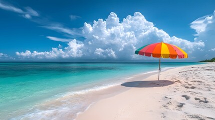Fototapeta premium Vibrant beach&nbsp;scene&nbsp;with rainbow-colored umbrella on&nbsp;sand, set&nbsp;against turquoise ocean and white&nbsp;clouds, capturing summer&nbsp;vacation essence&nbsp;with natural&nbsp;lighting in&nbsp;wide&nbsp;angle perspective.