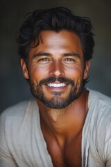 Fototapeta premium Handsome man with dark hair and facial hair smiling warmly, showcasing confidence and charm in a neutral backdrop