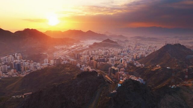 Aerial time lapse view showing crowds of pilgrims gathered around the Kaaba in the Grand Mosque, with construction cranes surrounding the site in Mecca (Makkah)