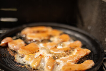 Chicken strips sizzling in a pan Time to eat