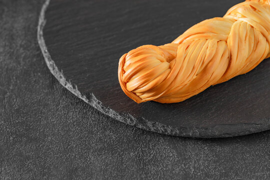 chechil cheese pigtailed on slate stone plate, selective focus